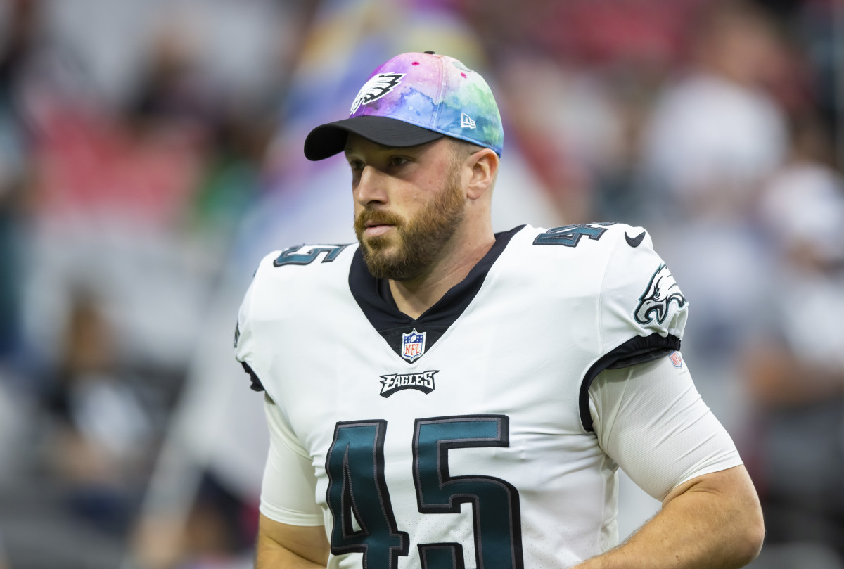 Eagles long snapper Rick Lovato stands on the field during warmups